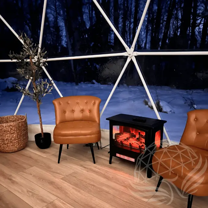 cozy chair with wood stove inside a geodesic dome
