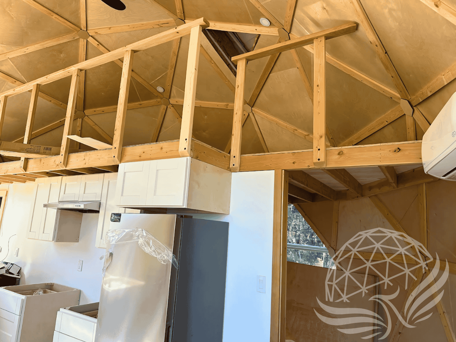 Kitchen and mezzanine inside a geodesic dome