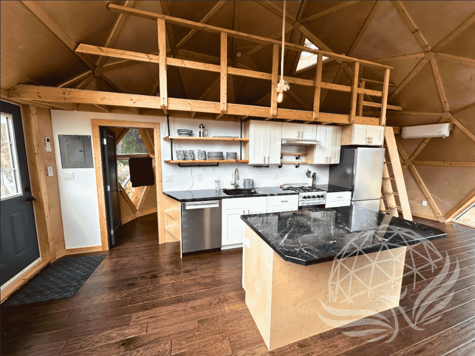 Kitchen and mezzanine inside a geodesic dome