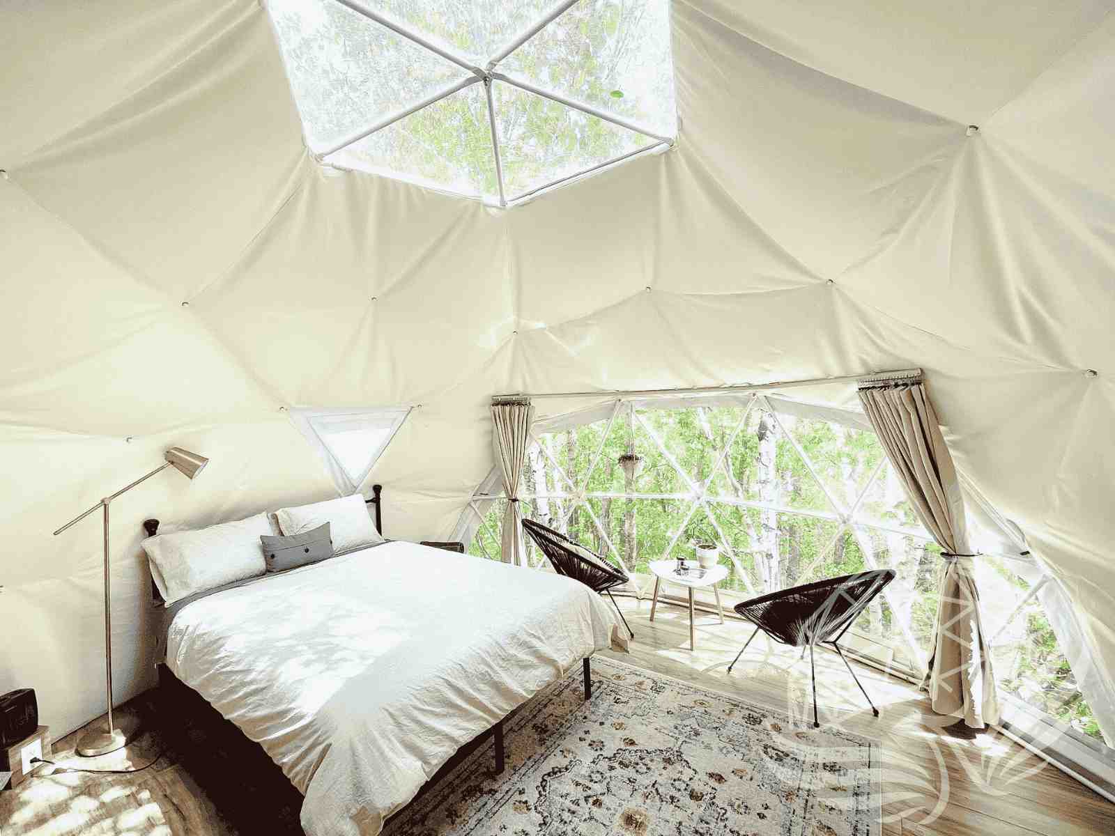 Bright dome bedroom with skylight and natural light flooding white bed