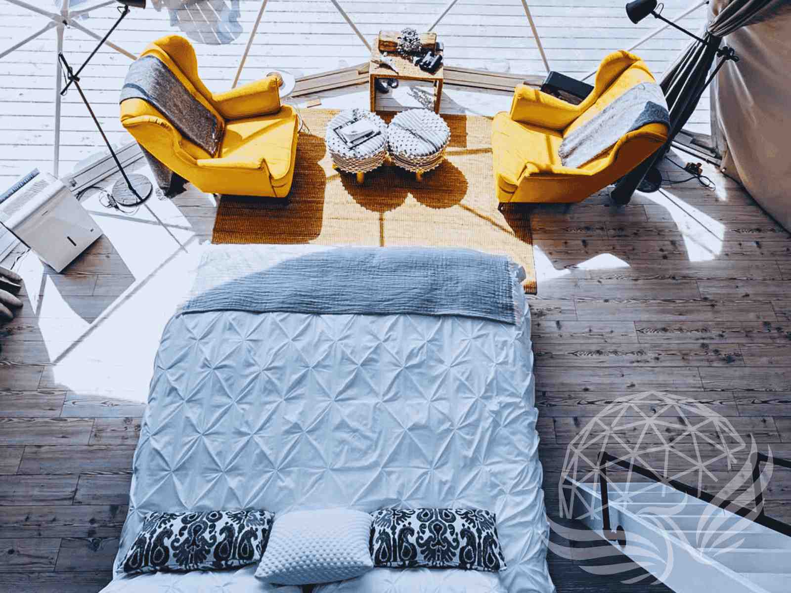 Stylish dome bedroom with yellow armchairs and snowy window view