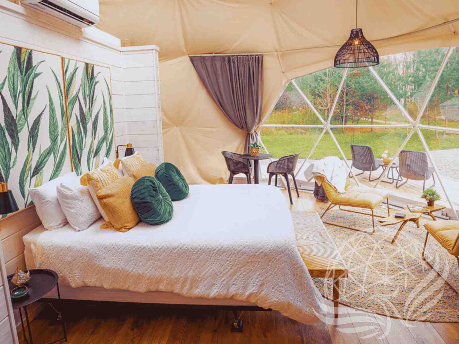 Earth-toned dome interior with rattan chair and large glass window