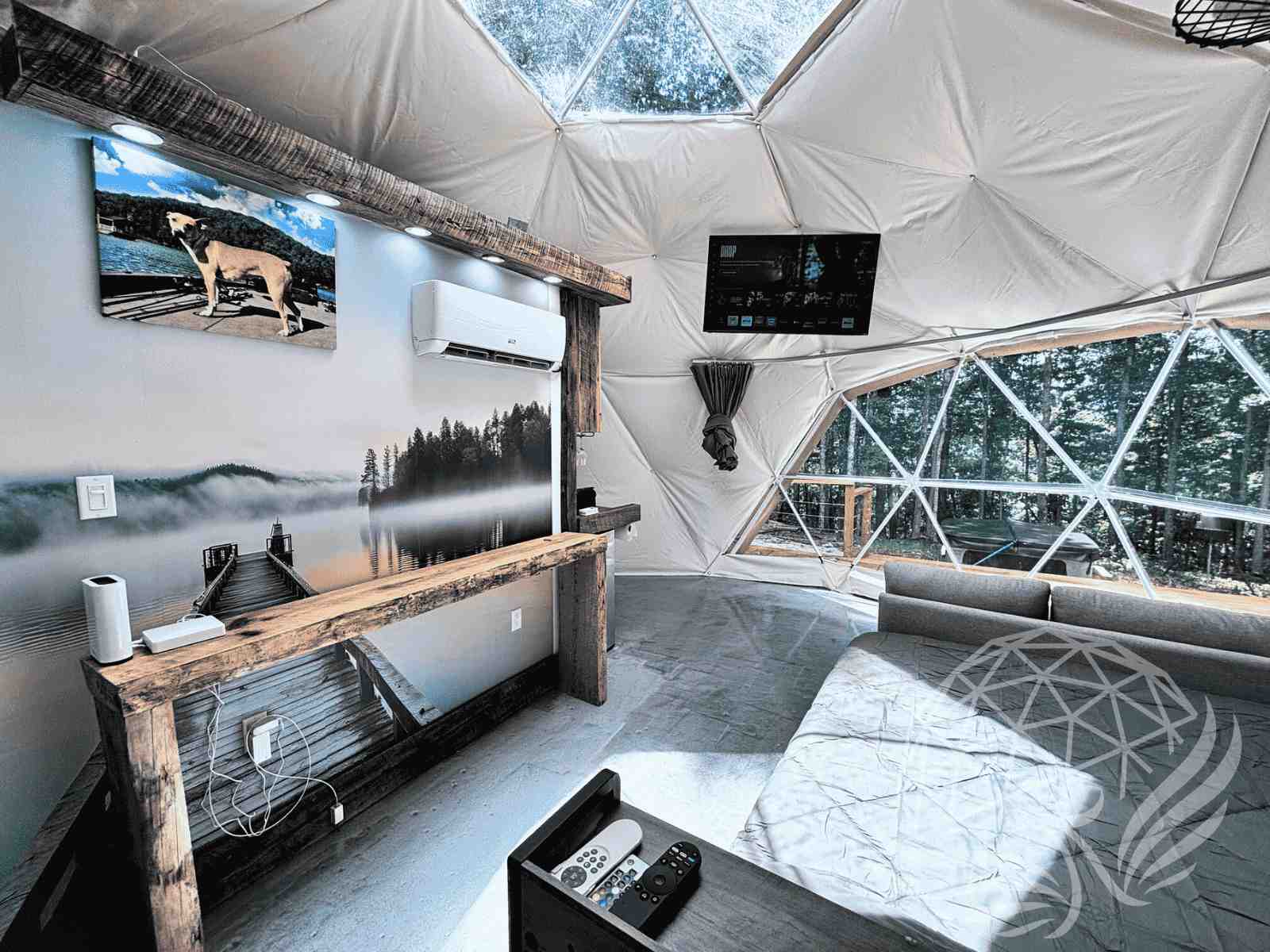 Modern dome interior with wood accents, air conditioner, and TV setup