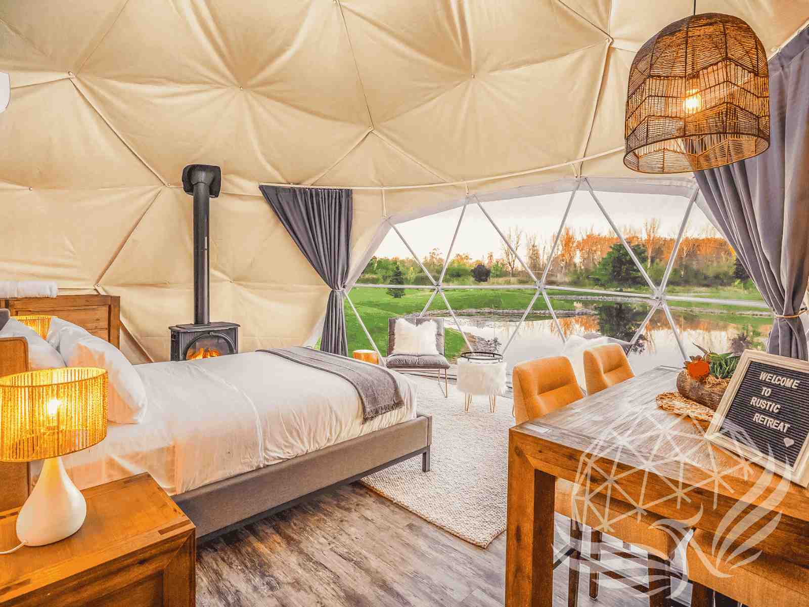 Upscale dome bedroom with lake view and rustic dining setup