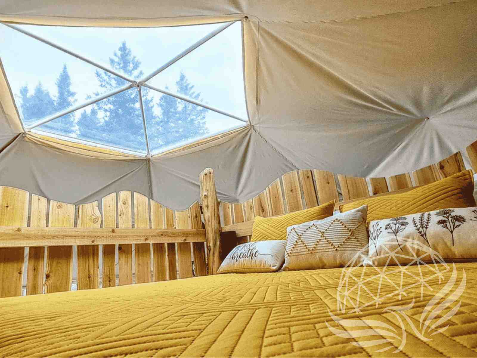 Dome loft bedroom with skylight view and rustic headboard