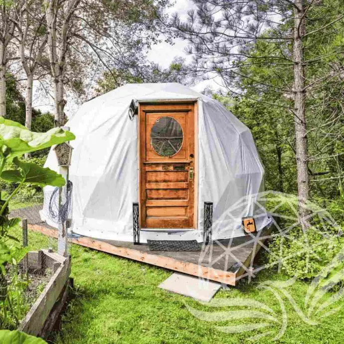 Geodesic Dome Specials – Deluxe Glamping & Residential Kits | Phoenix Domes 5M Deluxe Glamping Package geodesic dome with wooden door in forest setting