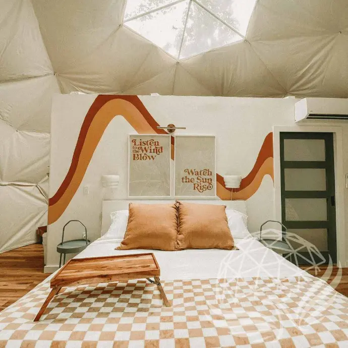 Cozy bedroom with retro wall design inside Moonshine Dome Retreat
