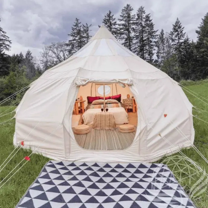 Teardrop Stargazer Tent with Cozy Interior | Phoenix Domes Teardrop Stargazer tent with stylish interior and forest backdrop, designed for premium glamping experiences.
