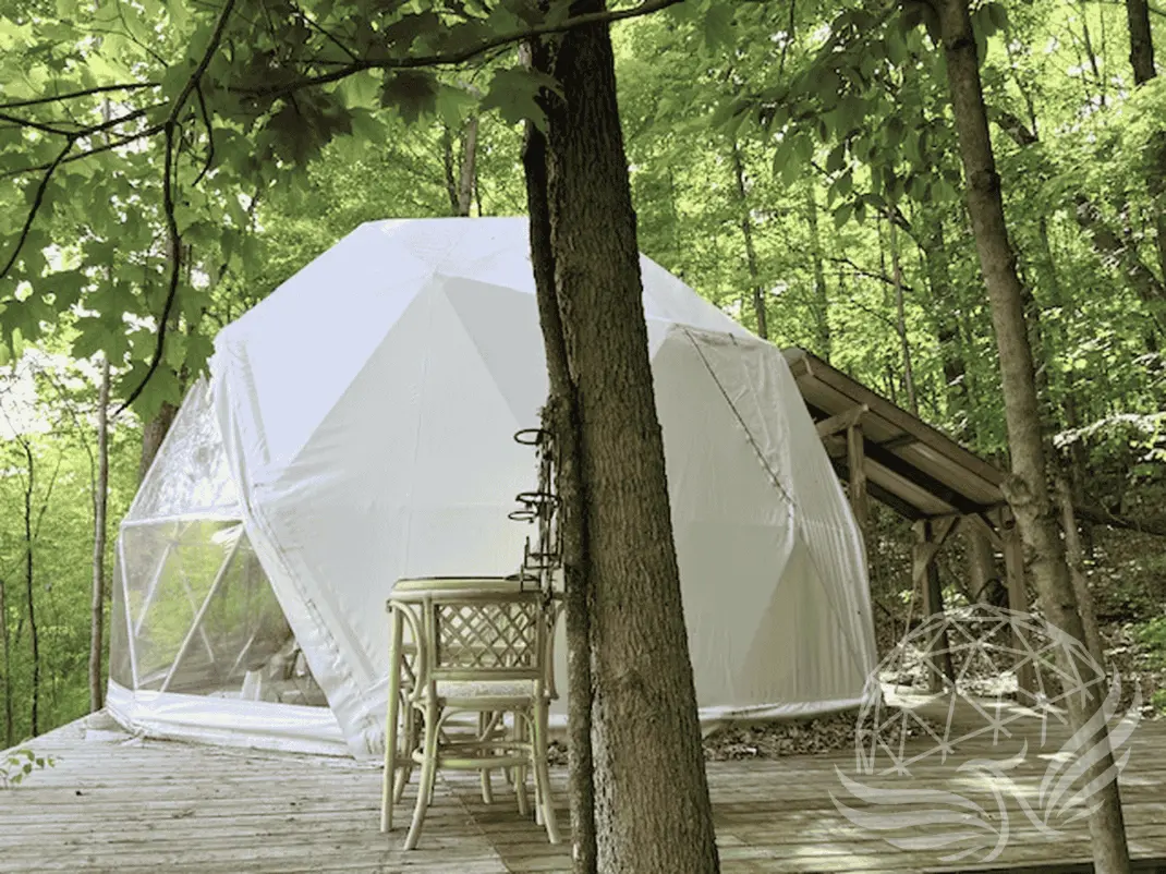 White geodesic dome on the forest setting