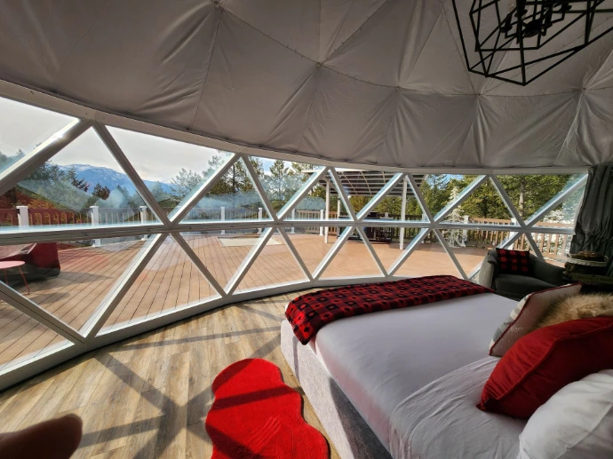 Bed overlooking a glass panorama window
