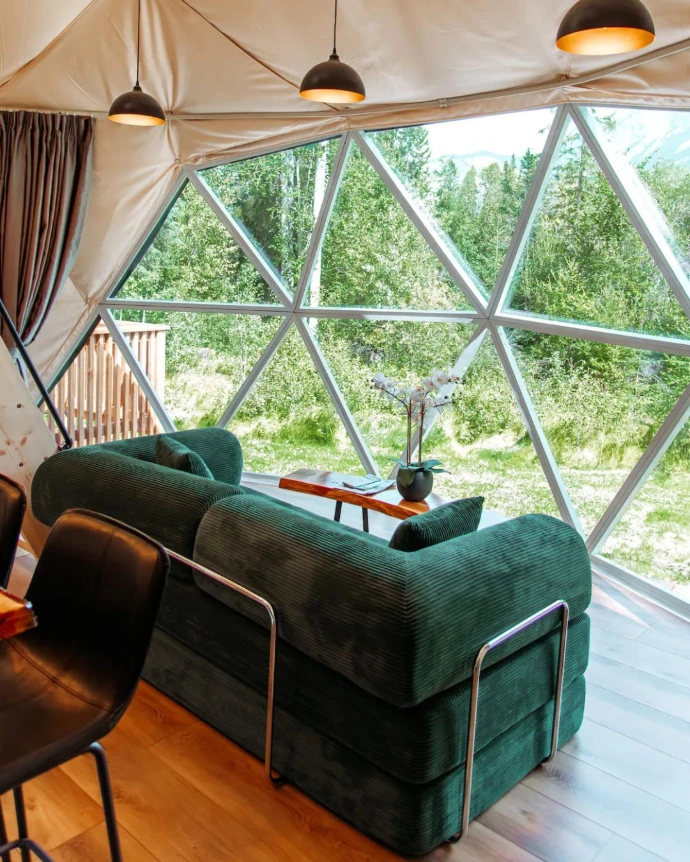 Green sofa inside a dome with glass panorama window